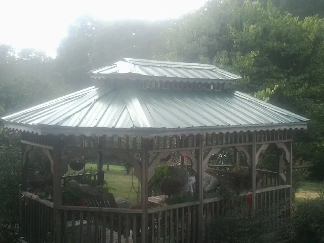 Two tier green metal roof on a garden gazebo in Orange